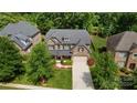 Aerial view of a two-story home and surrounding neighborhood at 4624 Pebble Run Dr, Matthews, NC 28105