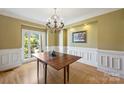 Elegant dining room with wainscoting and chandelier at 118 Broadbill Dr, Mooresville, NC 28117