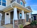 Covered porch with white columns and stone base at 1483 Honey Trl, Monroe, NC 28112