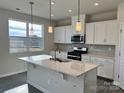 Modern kitchen with white cabinets and island at 1483 Honey Trl, Monroe, NC 28112