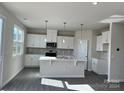 Modern kitchen with white cabinets and island at 1483 Honey Trl, Monroe, NC 28112