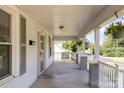 Inviting front porch with brick columns and hanging flower basket at 205 Martin Luther King Jr Ave, Salisbury, NC 28144