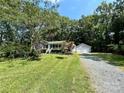 House exterior with attached garage and large yard at 2232 Stallings Rd, Matthews, NC 28104