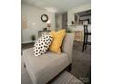 Light gray accent chair with patterned pillows at 195 Edward Ave # 13, Concord, NC 28025