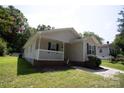 Tan house with a brick base, porch, and landscaping at 195 Edward Ave # 13, Concord, NC 28025