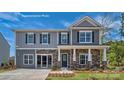 Two-story home with gray siding, stone accents, and a welcoming front porch at 198 Giant Oak Ave, Statesville, NC 28677