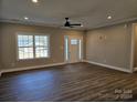 Bright living room with wood-look flooring and a front door with glass panes at 1886 Hollybrook Ln, Lancaster, SC 29720