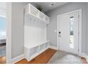 Entryway with built-in bench, cubbies, and hardwood floors at 2108 Bryant Park Dr, Charlotte, NC 28208