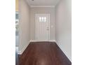 Light-filled entryway with dark hardwood floors and white door at 1346 Millview Ln, Matthews, NC 28104