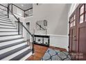 Elegant two-story entry with hardwood floors, a grand staircase, and a charming double door at 19577 Meta Rd, Cornelius, NC 28031