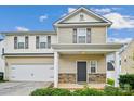 Two-story house with beige siding and stone accents at 14107 Rory Glen Ln, Charlotte, NC 28215