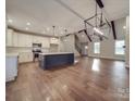 Open kitchen with island, stainless steel appliances, and hardwood floors at 4020 Landsford Rd, Marshville, NC 28103