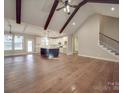 Spacious living room with hardwood floors, exposed beams, and high ceilings at 4020 Landsford Rd, Marshville, NC 28103