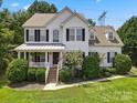 Two-story home with white siding and charming front porch at 1900 Mt Isle Harbor Dr, Charlotte, NC 28214