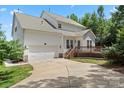 Two-story house with attached garage and deck, spacious driveway and backyard at 1900 Mt Isle Harbor Dr, Charlotte, NC 28214