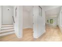 Bright hallway with light hardwood floors and staircase at 2112 Kirkwood Ave, Charlotte, NC 28203