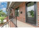 Brick front porch with black railings and door at 2112 Kirkwood Ave, Charlotte, NC 28203