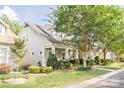 Tan house with front porch and landscaped yard at 569 Channel Rd, Clover, SC 29710