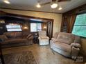 Relaxing living room with comfortable seating and a fireplace at 113 Hummingbird Cir, New London, NC 28127