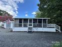 Mobile home with screened porch and small shed at 113 Hummingbird Cir, New London, NC 28127