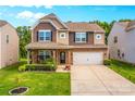 Two-story house with stone and brown siding, a two-car garage, and landscaping at 133 Lassen Ln, Mooresville, NC 28117