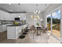 Modern kitchen with island, white cabinets, and breakfast nook at 103 Dublin Ct, Statesville, NC 28677