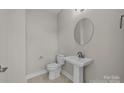 Small powder room with pedestal sink and toilet at 107 Dublin Ct, Statesville, NC 28677