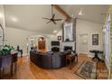 Spacious living room with hardwood floors, fireplace, and a large sectional sofa at 4364 Hager Mountain Ln, Iron Station, NC 28080