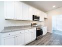 Modern kitchen with granite countertops and stainless steel appliances at 812 Hardin St, Lancaster, SC 29720