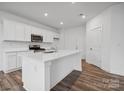 Modern kitchen featuring white cabinets and a large island at 723 Olde England Dr, Lincolnton, NC 28092