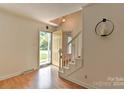 Bright entryway with hardwood floors, staircase, and access to the backyard at 13901 Phillips Rd, Matthews, NC 28105