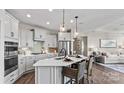 Modern kitchen with island, stainless steel appliances, and white cabinetry at 7567 Baybrooke Ln # 35, Harrisburg, NC 28075
