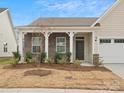 Brick front home with covered porch and landscaping at 1045 Bull Dog Ln, Wingate, NC 28174