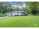 Ranch home with blue accents and a spacious lawn at 301 6Th Se St, Belmont, NC 28012