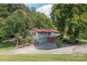 Ranch-style home with red roof, two-car garage, and landscaping at 4120 Statesville Blvd, Salisbury, NC 28147