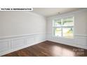 Formal dining room featuring hardwood floors and white wainscoting at 115 Saidin Ln, Troutman, NC 28166