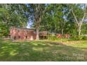 Large backyard with mature trees and a deck at 1573 Timberlake Dr, Shelby, NC 28150