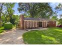 Red brick ranch house with double doors and a spacious yard at 1573 Timberlake Dr, Shelby, NC 28150