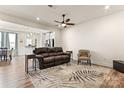 Open living room with leather couch, accent chair, and view to kitchen at 1446 Crest Creek Ct, Clover, SC 29710