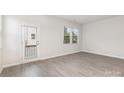 Empty bedroom with gray vinyl plank flooring and door to balcony at 2307 Via Dei Conte Aly, Charlotte, NC 28205