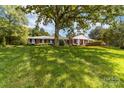 Ranch-style home with brick facade and lush lawn at 3029 River Rd, Shelby, NC 28152