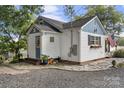 Side view of charming cottage with stone patio at 710 N Central Ave, Locust, NC 28097