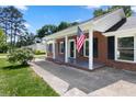 Charming covered porch with brick columns and an American flag at 2009 Echo Ln, Gastonia, NC 28052