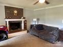 Cozy living room featuring a brick fireplace and comfortable couch at 331 Polk Ford Rd, Stanfield, NC 28163