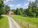 Gravel driveway leading to a brick house on a large lot at 4055 Dakeita Cir, Concord, NC 28025