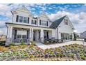 Two story home with white siding, gray stone accents, and a three-car garage at 3245 Mcharney Dr # 28, Harrisburg, NC 28075