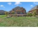 Landscaped backyard with stone retaining walls and patio at 312 Wintergreen Ct, Kings Mountain, NC 28086