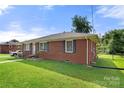 Another side view of the brick house with landscaping at 117 Bolding St, Gastonia, NC 28052