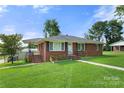Front view of a charming brick ranch house with landscaping at 117 Bolding St, Gastonia, NC 28052
