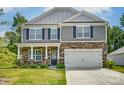Two-story house with gray siding and stone accents at 208 Wildflower Dr, Locust, NC 28097